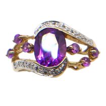 A VINTAGE 9CT GOLD, PURPLE SAPPHIRE, DIAMOND AND SPINEL RING Having central oval cut purple sapphire