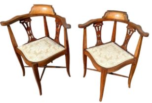 A PAIR OF EDWARDIAN MAHOGANY AND INLAID CORNER CHAIRS With pierced back and upholstered seats.