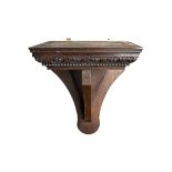 A CARVED WOODEN WALL BRACKET Decorated with repeating leaf and rope twist decoration. (h 47.5cm x