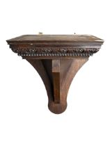 A CARVED WOODEN WALL BRACKET Decorated with repeating leaf and rope twist decoration. (h 47.5cm x