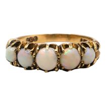 A VINTAGE 9CT GOLD AND OPAL RING Having five graduated round cabochon cut opals (largest approx.