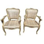 A PAIR OF FRENCH LOUIS XVI DESIGN CARVED WOOD AND PAINTED OPEN ARMCHAIRS The shape back decorated