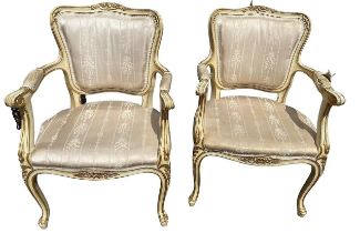 A PAIR OF FRENCH LOUIS XVI DESIGN CARVED WOOD AND PAINTED OPEN ARMCHAIRS The shape back decorated