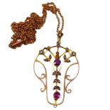 AN EDWARDIAN 9CT ART NOUVEAU, AMETHYST AND SEED PEARL PENDANT Attached with a 9ct gold cable link