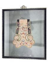 A 19TH CENTURY CHINESE PART SILK EMBROIDERED ROBE FRAGMENT Depicting two figures amongst flower