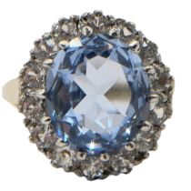 A VINTAGE 9CT GOLD, BLUE TOPAZ AND WHITE TANZANITE RING Having central oval cut blue topaz (