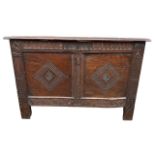 A 17TH CENTURY CARVED OAK PANELLED COFFER With hinge lid the front carved with initials ‘ST’,