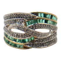 A 9CT GOLD, EMERALD AND DIAMOND RING Having a stylised crossover front, inset with round cut