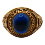 A LARGE VINTAGE 9CT GOLD AND BLUE GLASS UNIVERSITY OF LIFE RING Having oval cabochon cut blue