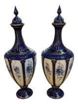 ROYAL WORCESTER, A PAIR OF EARLY 20TH CENTURY PORCELAIN LIDDED VASES Floral blue and white panels on