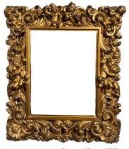 AN 18TH CENTURY ITALIAN FLORENTINE CARVED GILTWOOD MIRROR Decorated with scrolling foliage and