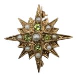 A VINTAGE 9CT GOLD, PERIDOT AND PEARL STAR BROOCH Sixteen point star having chased and engraved
