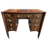 MANNER OF GILLOWS, A 19TH CENTURY REGENCY MAHOGANY AND EBONY LINE INLAID BOW FRONTED WRITING TABLE