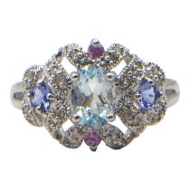 A 9CT WHITE GOLD, DIAMOND, AQUAMARINE, IOLITE AND PINK SPINEL RING Having central oval cut