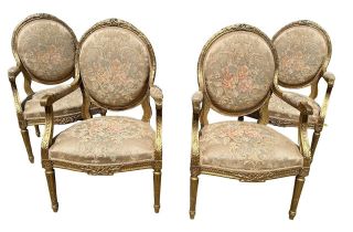 A GOOD SET OF FOUR LOUIS XVI DESIGN 19TH CENTURY FRENCH CARVED GILTWOOD OPEN ARMCHAIRS The oval back