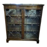 AN EARLY 20TH CENTURY MAHOGANY FLOOR STANDING BOOKCASE With two lancet doors enclosing adjustable