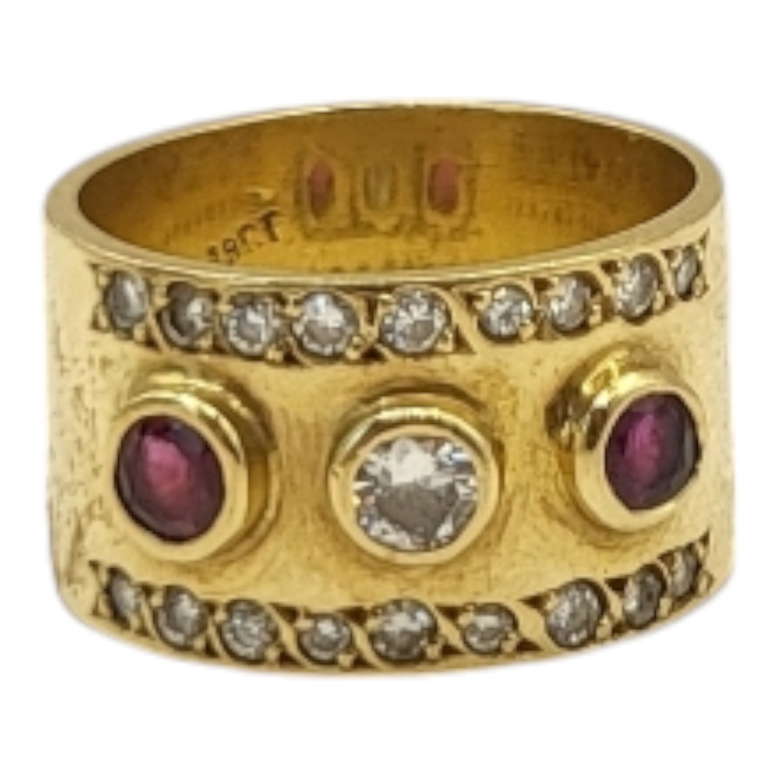 A YELLOW METAL, RUBY AND DIAMOND THREE STONE RING The central round cut diamond flanked with rubies,