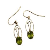 A PAIR OF VINTAGE YELLOW METAL AND PERIDOT EARRINGS Oval cut peridot in a pierced design. (approx