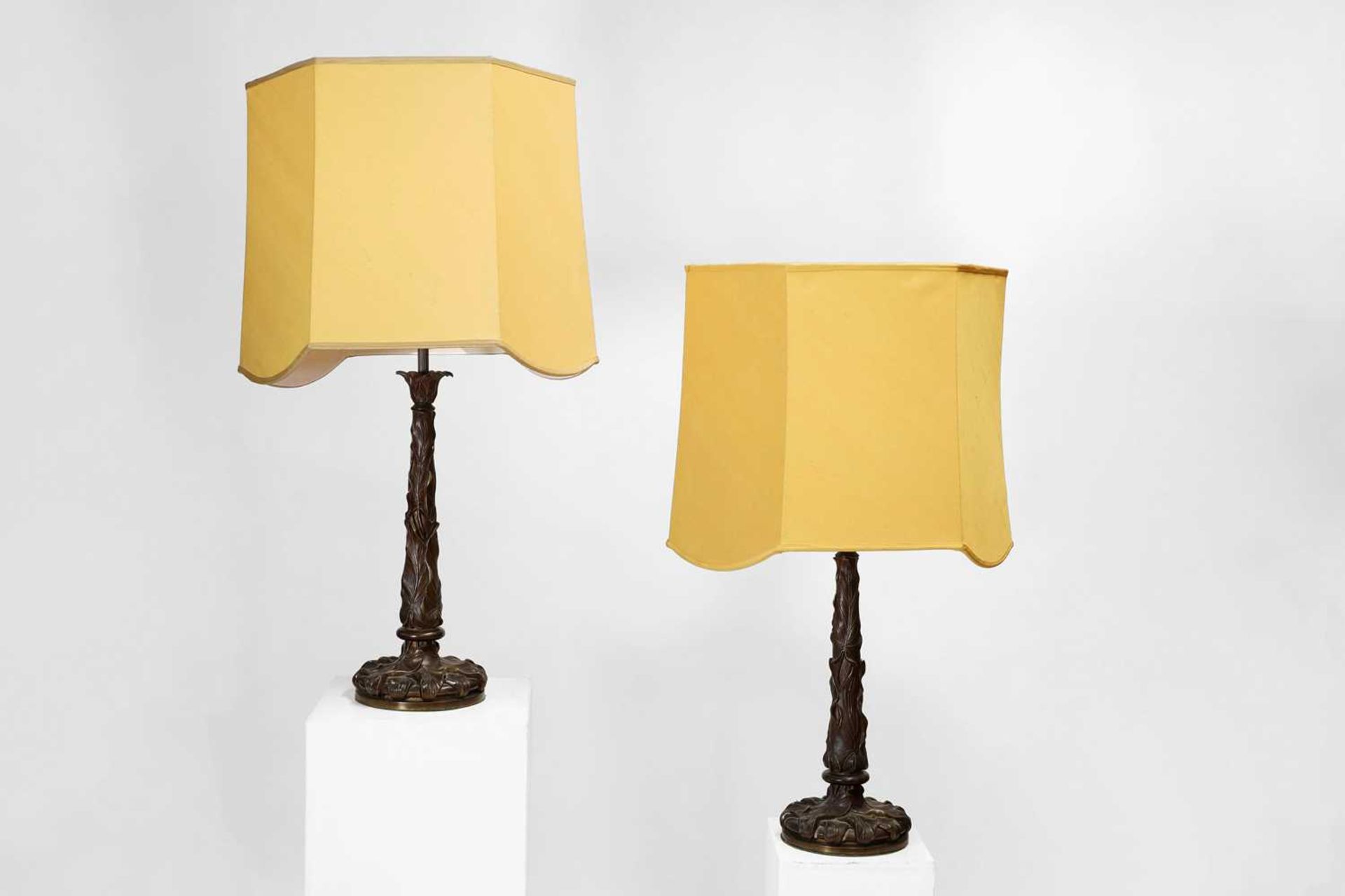 A pair of patinated bronze table lamps,