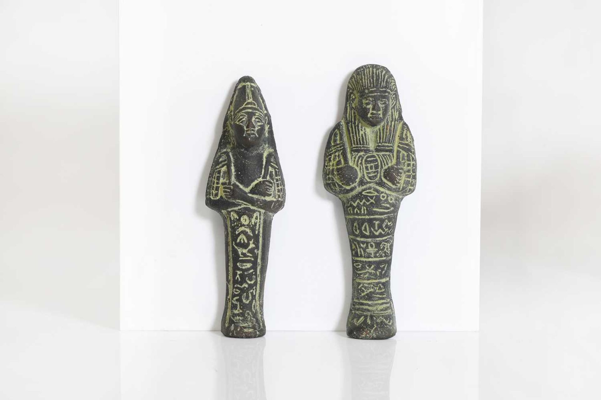 A pair of Egyptian-style clay ushabti figures,