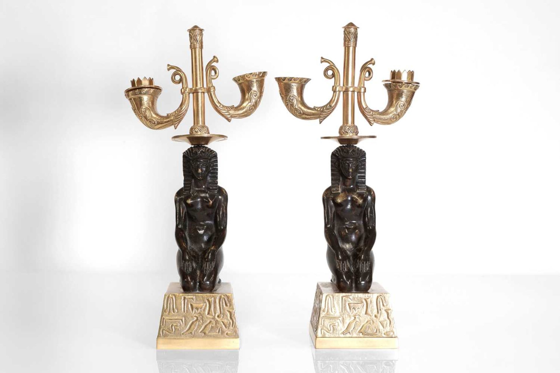 A pair of Empire-style gilt and patinated bronze candelabra,