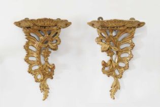 A pair of carved giltwood wall brackets,