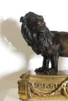 A patinated bronze figure of a lion,