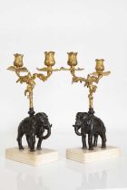 A pair of gilt and patinated bronze candelabra,