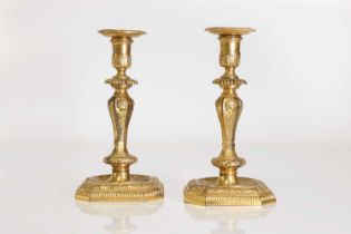 A pair of Régence-style ormolu candlesticks,