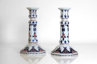 A pair of faience candlesticks,