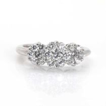 A white gold diamond set triple floral cluster ring,