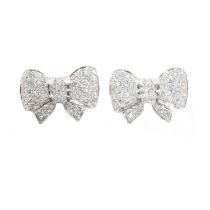 A pair of platinum and diamond bow-style stud earrings,