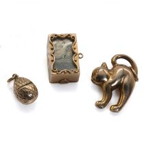 A group of three gold charms,