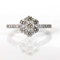 A platinum and diamond daisy cluster ring,