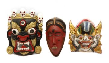 A group of three painted wood masks