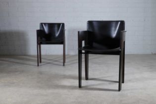 A pair of Dutch leather and stained beech armchairs,
