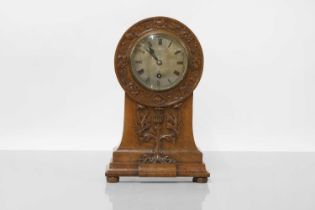A Scottish Arts and Crafts oak mantel clock,