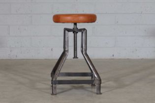 An industrial tubular steel machinist's stool,