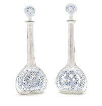 A pair of enamelled glass decanters,