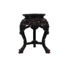 A carved hardwood jardiniere stand