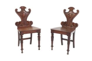 A pair of William IV mahogany hall chairs