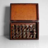 A set of brass alphabet bookbinder's lettering tools,