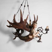 A polychrome, carved wood and antler five-light chandelier,