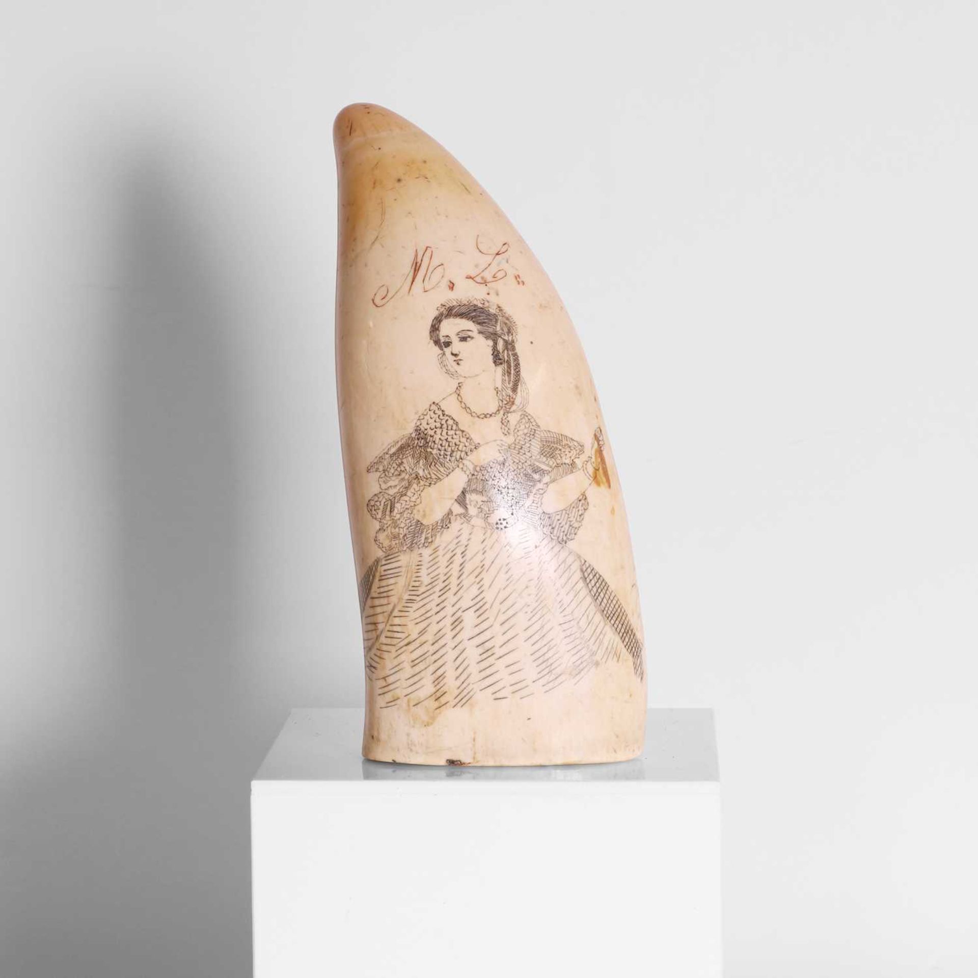 A scrimshaw-decorated sperm whale's tooth,