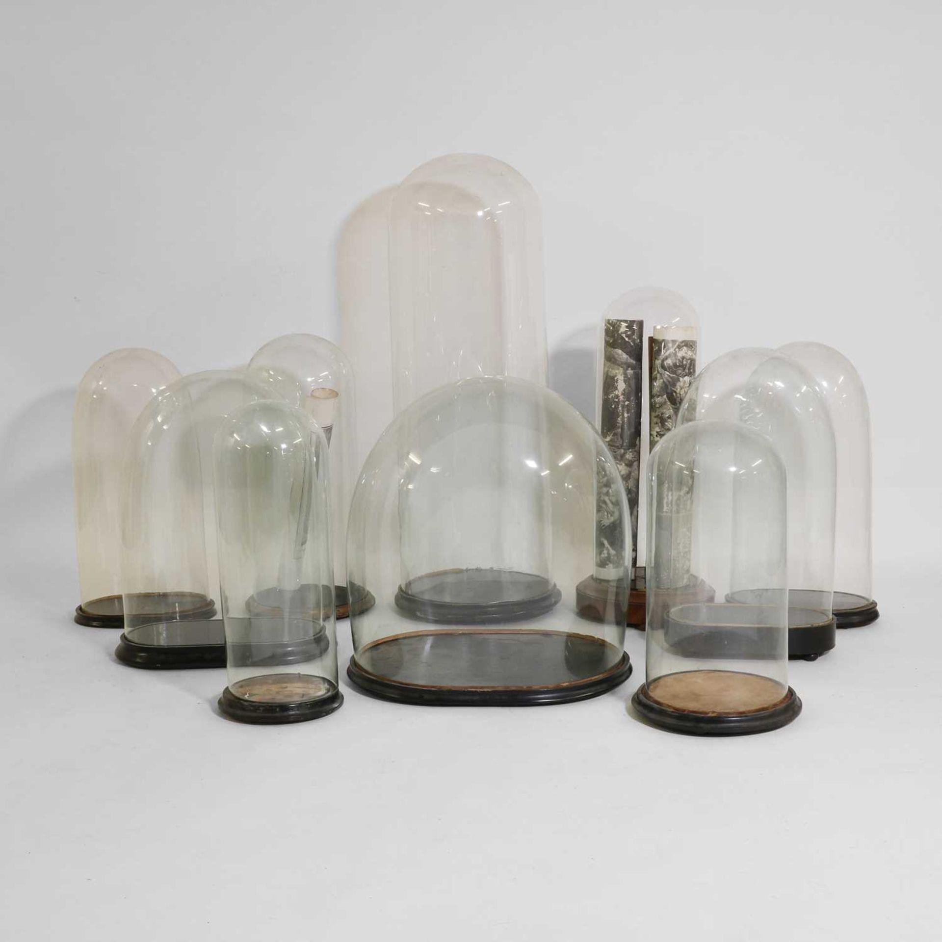 A group of ten Victorian glass domes,