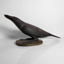 A carved and painted model of a crow,