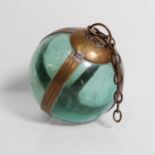 A brass-mounted pale-green glass buoy or fishing float,