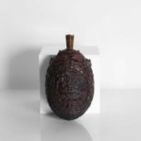 A carved coconut 'bugbear' flask,