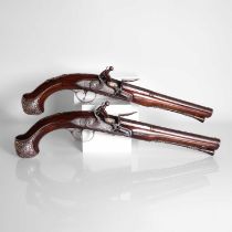 A pair of 16-bore silver-mounted flintlock duelling pistols,