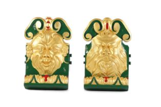 A pair of relief-carved grotesque fairground carousel panels by C J Spooner,